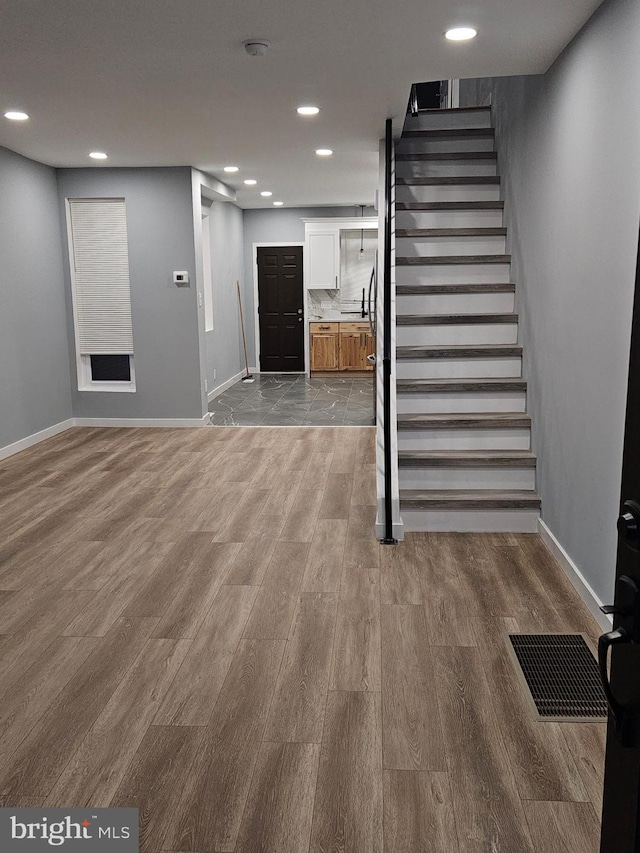 stairway featuring hardwood / wood-style floors