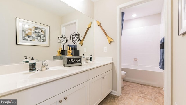 full bathroom with vanity, toilet, and shower / tub combination