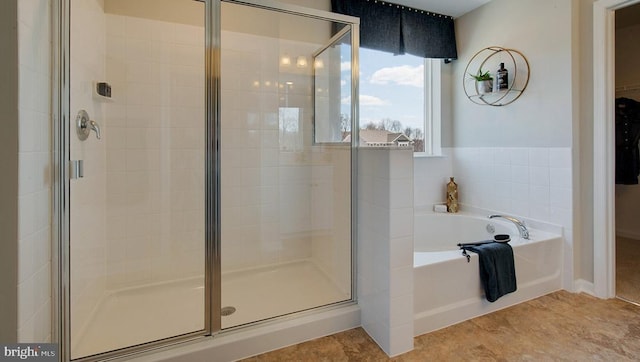 bathroom with tile patterned floors and independent shower and bath