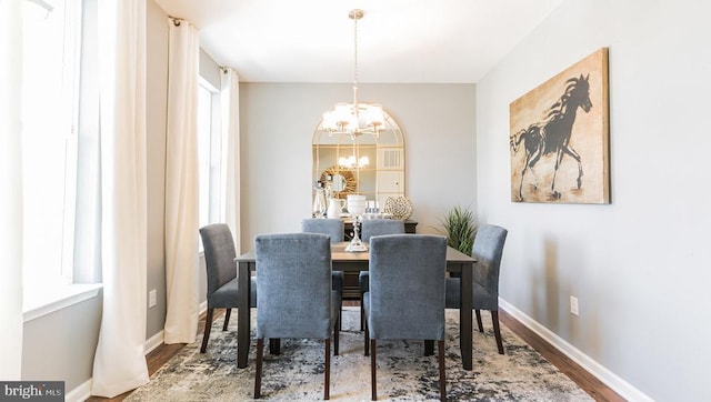 dining room with a chandelier and wood-type flooring