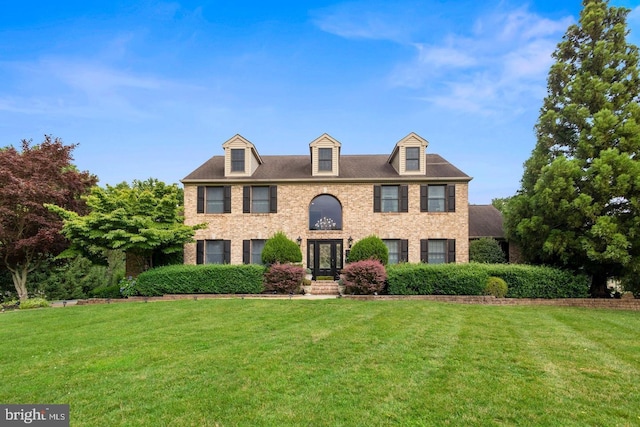 colonial home featuring french doors and a front yard