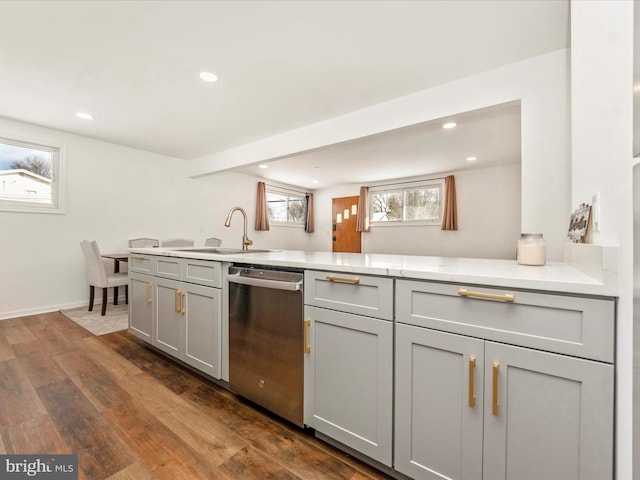 kitchen featuring dishwasher, dark hardwood / wood-style flooring, gray cabinets, and sink