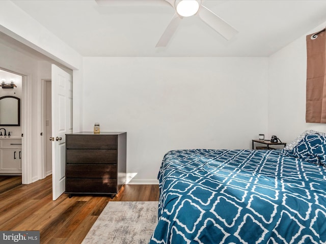 bedroom with dark hardwood / wood-style floors and ceiling fan