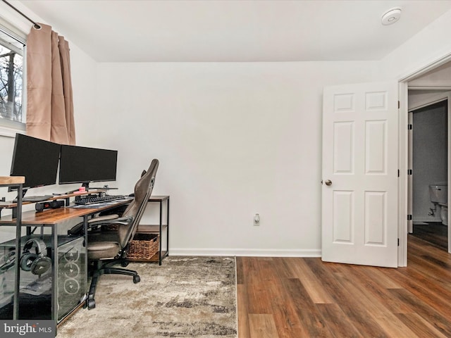 home office with hardwood / wood-style floors