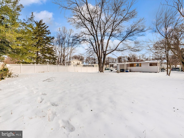 view of yard layered in snow