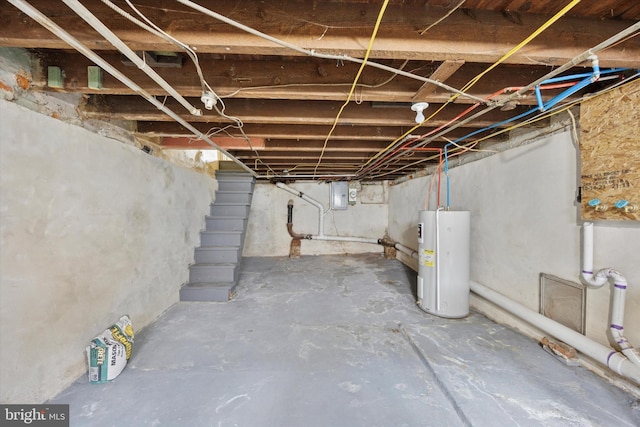 unfinished below grade area featuring water heater and electric panel