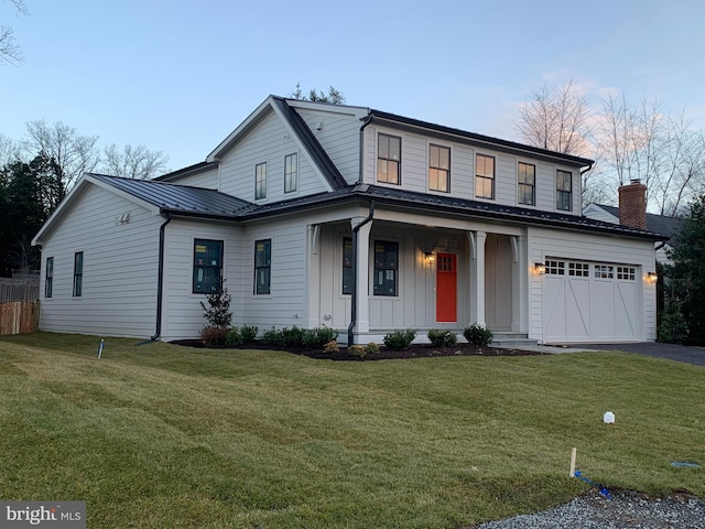 view of front of property with a front yard, a porch, and a garage