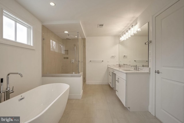 full bathroom featuring a walk in shower, a freestanding tub, a sink, baseboards, and double vanity