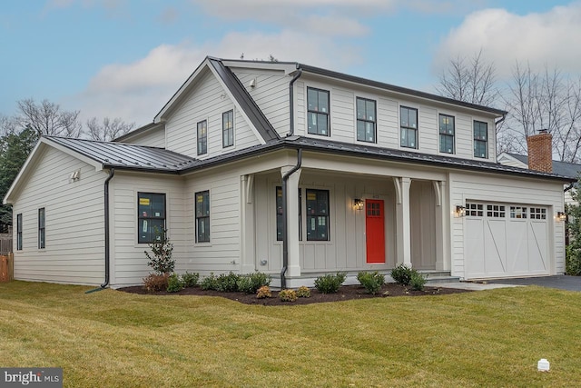 view of front of house featuring a front lawn, covered porch, and a garage