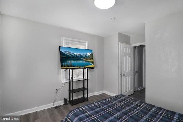 bedroom with dark hardwood / wood-style floors