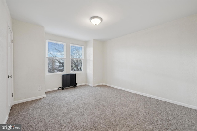 unfurnished room featuring radiator and carpet floors