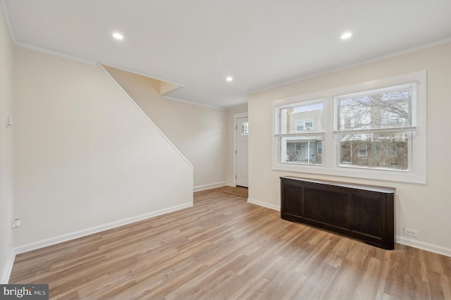 interior space with radiator and light hardwood / wood-style floors