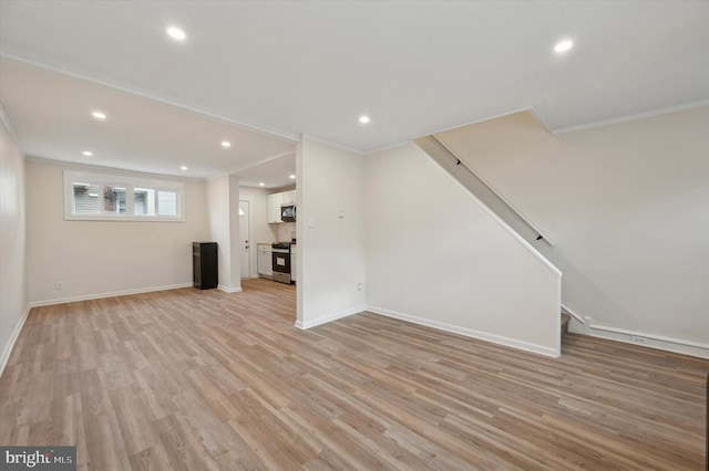 unfurnished living room featuring crown molding and light wood-type flooring