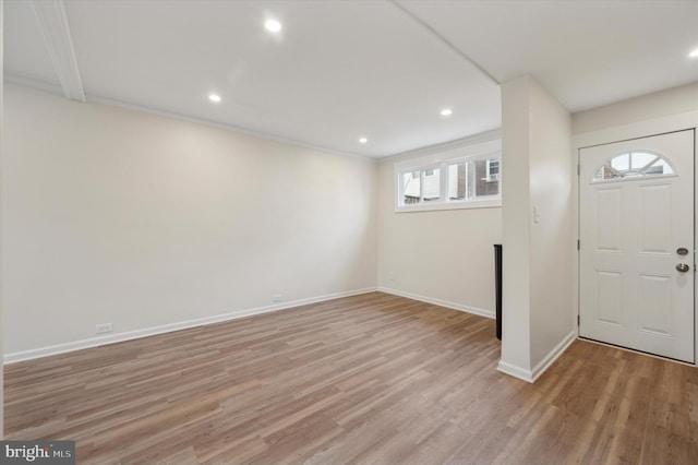 foyer featuring light hardwood / wood-style floors and crown molding