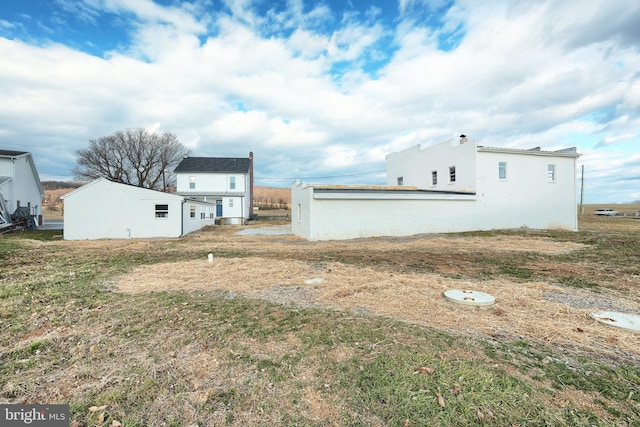 view of property exterior with a lawn