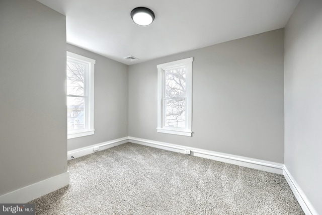 unfurnished room featuring carpet