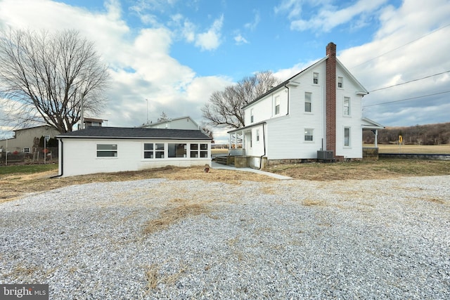 back of property featuring central AC