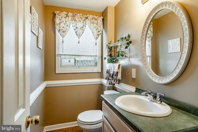 bathroom featuring vanity and toilet