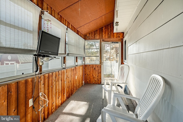 sunroom / solarium featuring vaulted ceiling