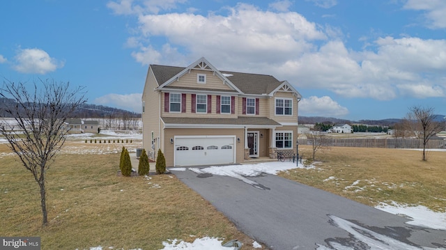 view of front of property featuring a garage and a front yard