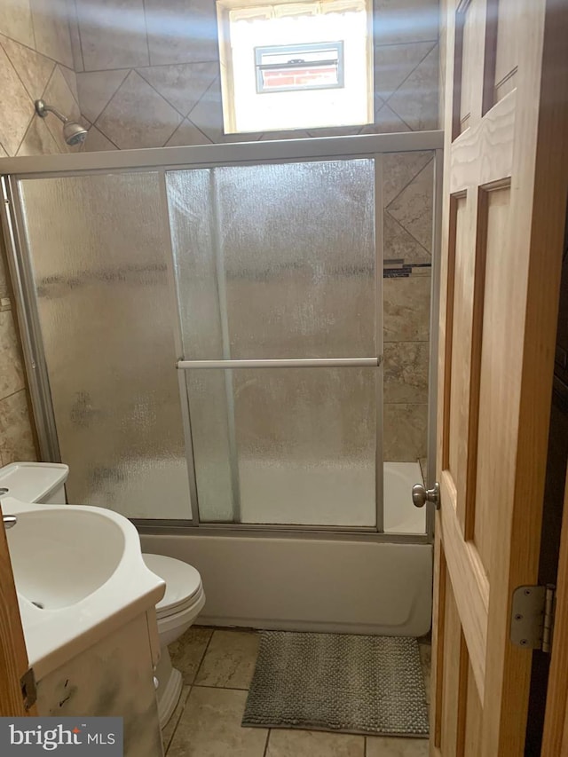 full bathroom featuring tile patterned flooring, vanity, toilet, and enclosed tub / shower combo