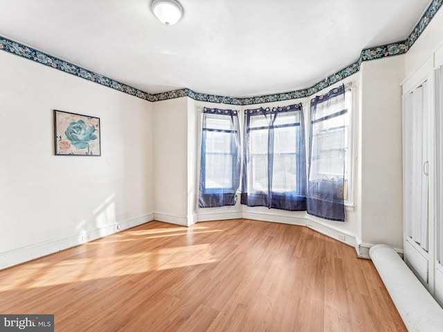 spare room with hardwood / wood-style floors