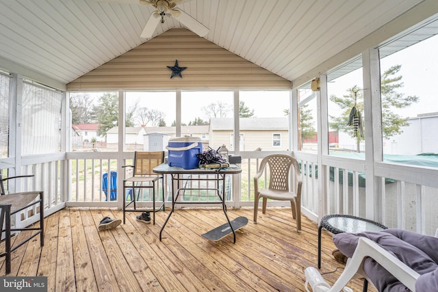 sunroom / solarium with ceiling fan and lofted ceiling