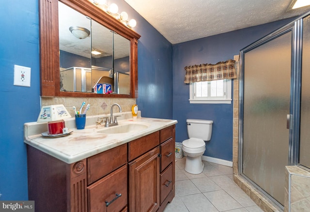 bathroom featuring tile patterned floors, vanity, a textured ceiling, and walk in shower