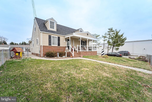 new england style home with covered porch and a front lawn