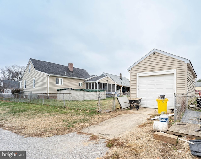 exterior space with a garage and a sunroom