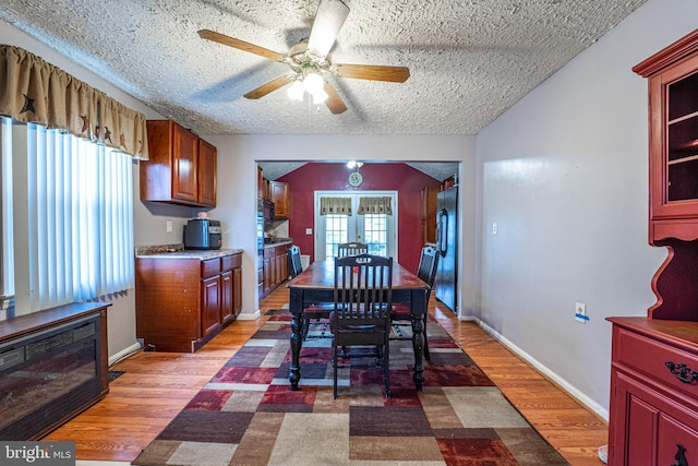 dining area with french doors, a wealth of natural light, ceiling fan, and wood-type flooring