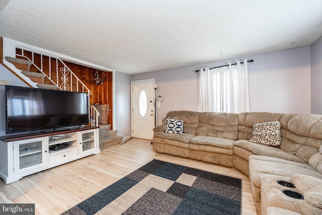 living room with a textured ceiling and hardwood / wood-style flooring