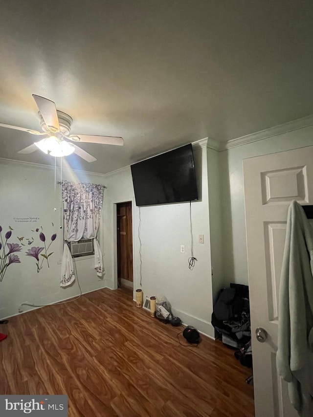 unfurnished bedroom featuring ceiling fan, hardwood / wood-style floors, and ornamental molding