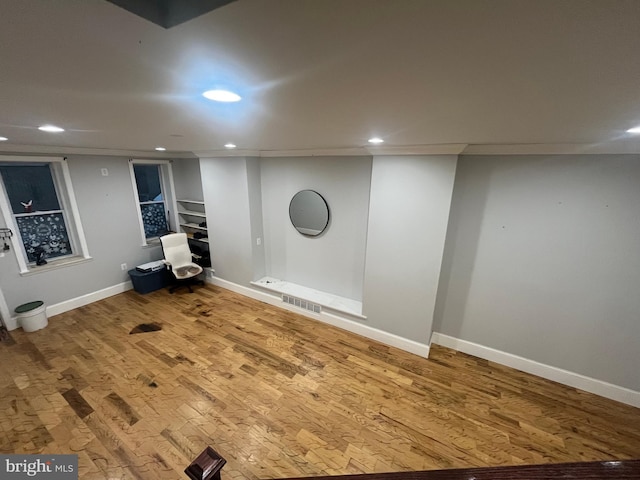 basement with hardwood / wood-style flooring