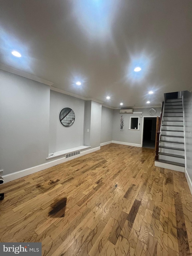 basement with crown molding and hardwood / wood-style flooring