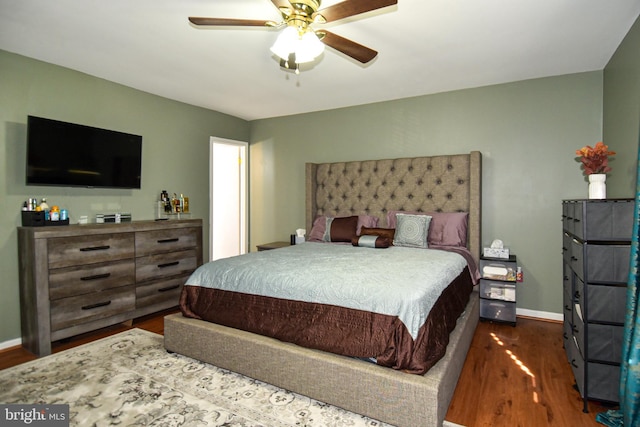 bedroom with dark hardwood / wood-style flooring and ceiling fan