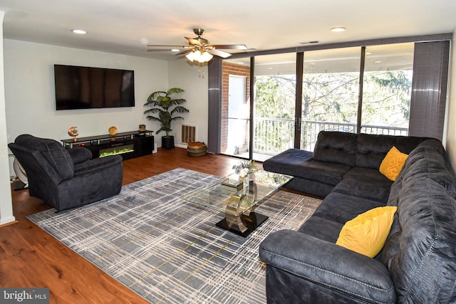 living room with dark hardwood / wood-style floors and ceiling fan