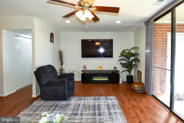 living room featuring hardwood / wood-style floors, ceiling fan, and a healthy amount of sunlight