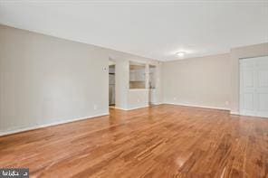 unfurnished living room featuring wood-type flooring