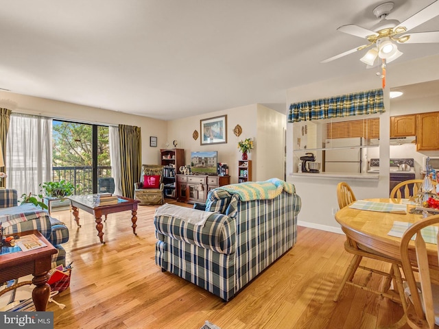 living room featuring light hardwood / wood-style flooring and ceiling fan