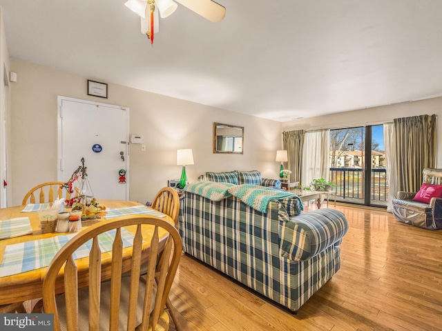 living room with ceiling fan and light hardwood / wood-style floors