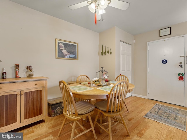 dining room with ceiling fan and light hardwood / wood-style floors