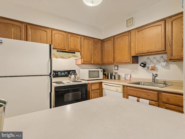 kitchen featuring white appliances and sink