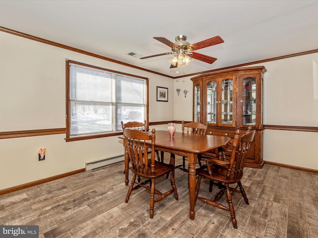 dining area with a baseboard radiator, ceiling fan, and ornamental molding