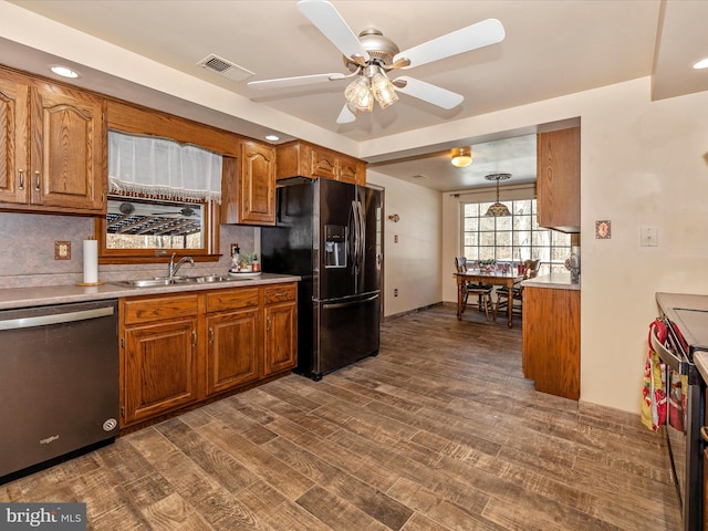 kitchen with appliances with stainless steel finishes, tasteful backsplash, ceiling fan, sink, and pendant lighting