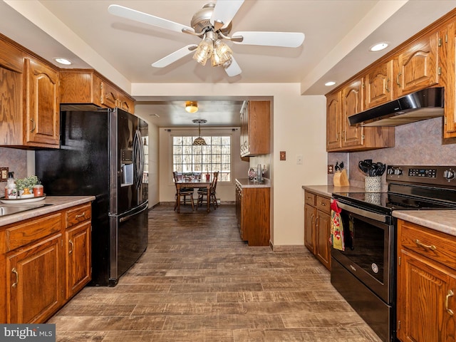 kitchen with ceiling fan, dark hardwood / wood-style flooring, pendant lighting, decorative backsplash, and black appliances