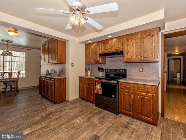 kitchen featuring tasteful backsplash, black / electric stove, ceiling fan, and dark hardwood / wood-style flooring