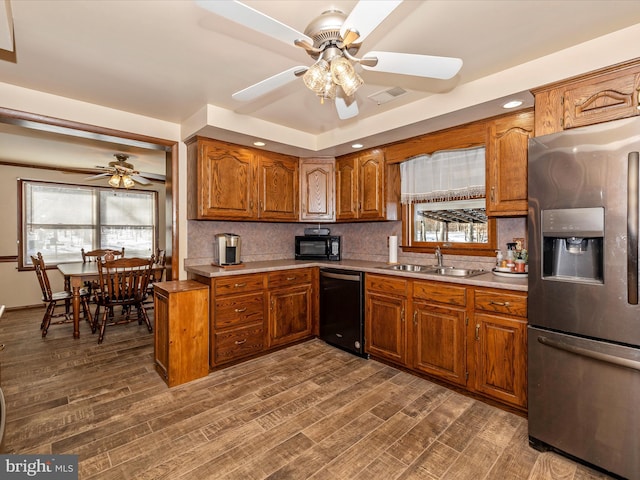 kitchen with backsplash, dark wood-type flooring, black appliances, sink, and ceiling fan