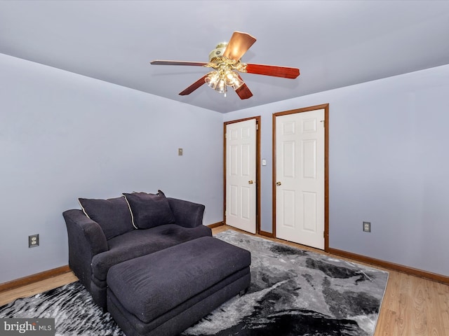 living room with wood-type flooring and ceiling fan