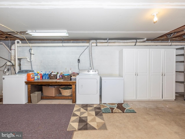 basement featuring washer and dryer and fridge